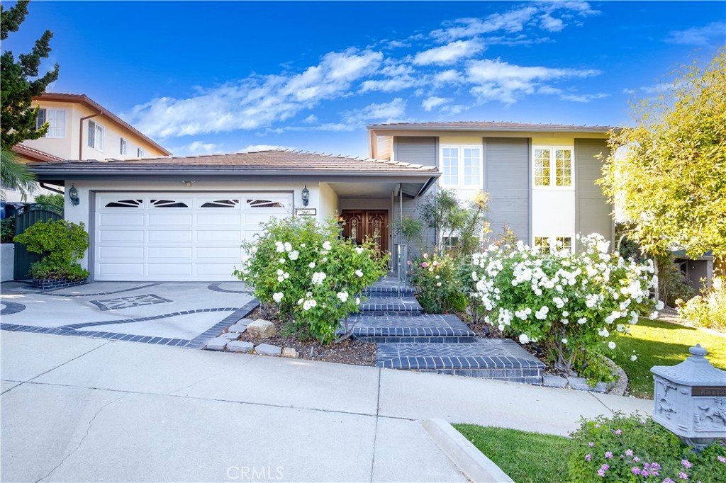 a front view of a house with a yard and a garage