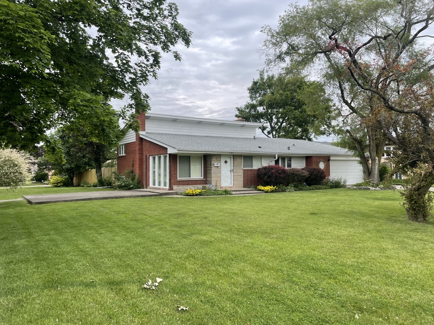 a front view of a house with a garden