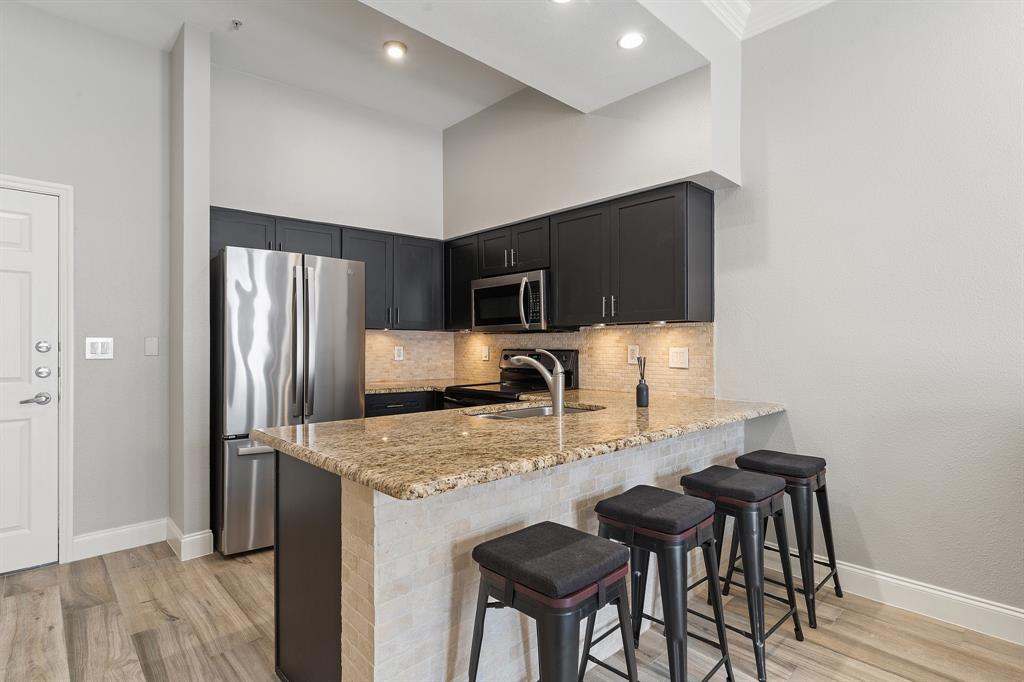 a kitchen with kitchen island a counter top space appliances and cabinets