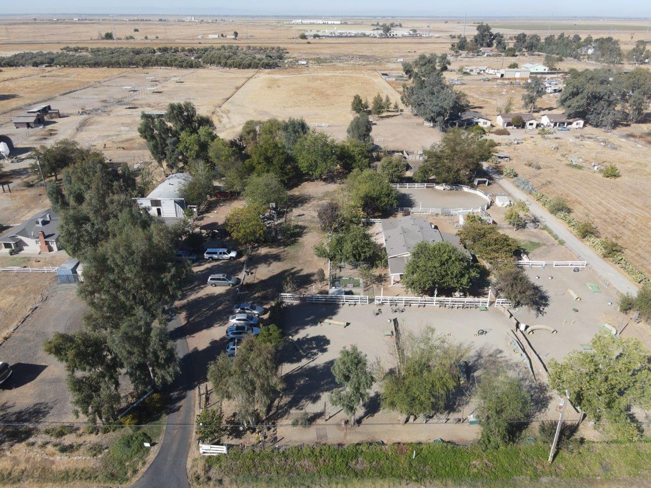 an aerial view of house with yard and ocean view