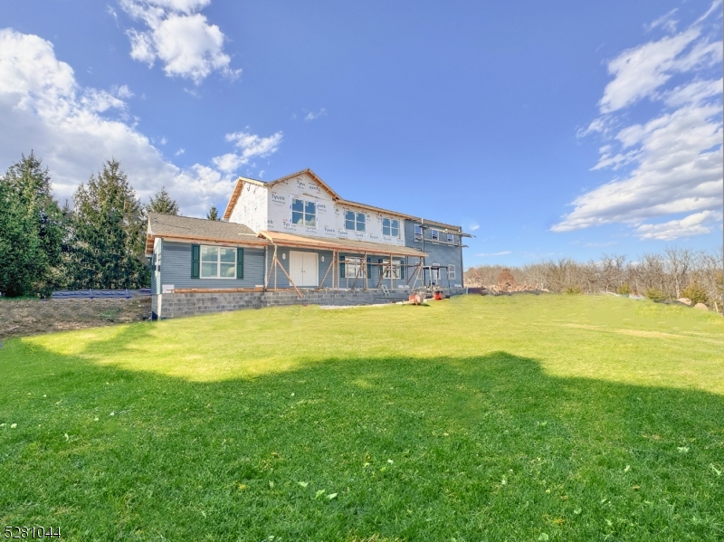 a front view of a house with a big yard