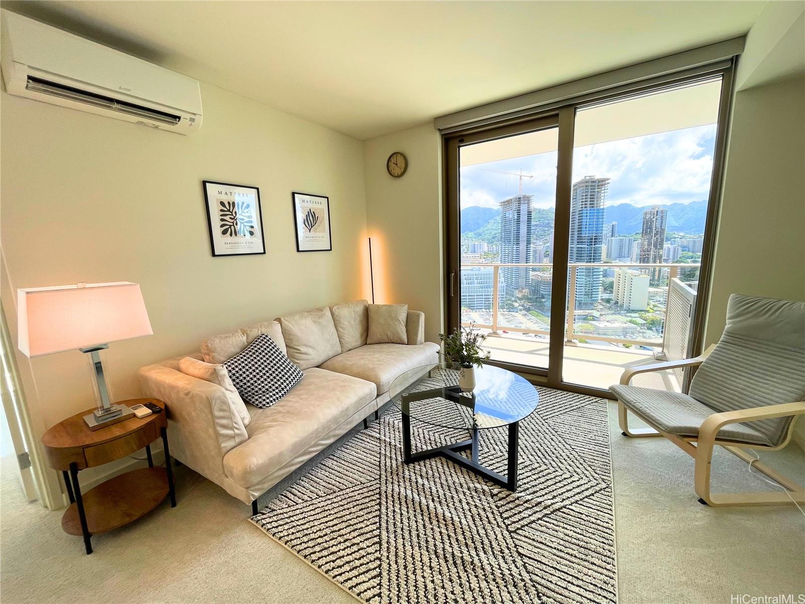 a living room with furniture and a lamp with a large window