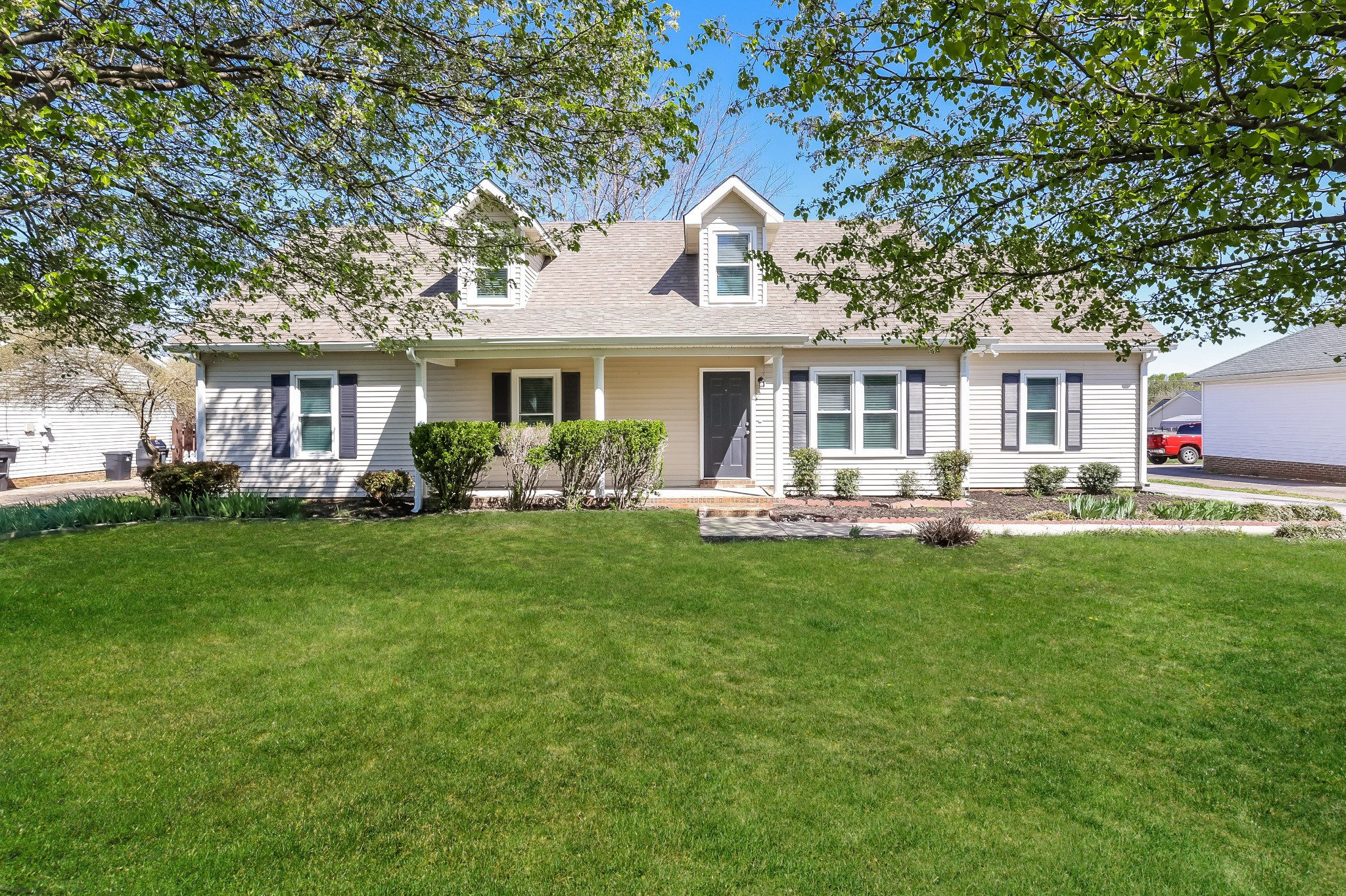 a front view of house with yard and green space