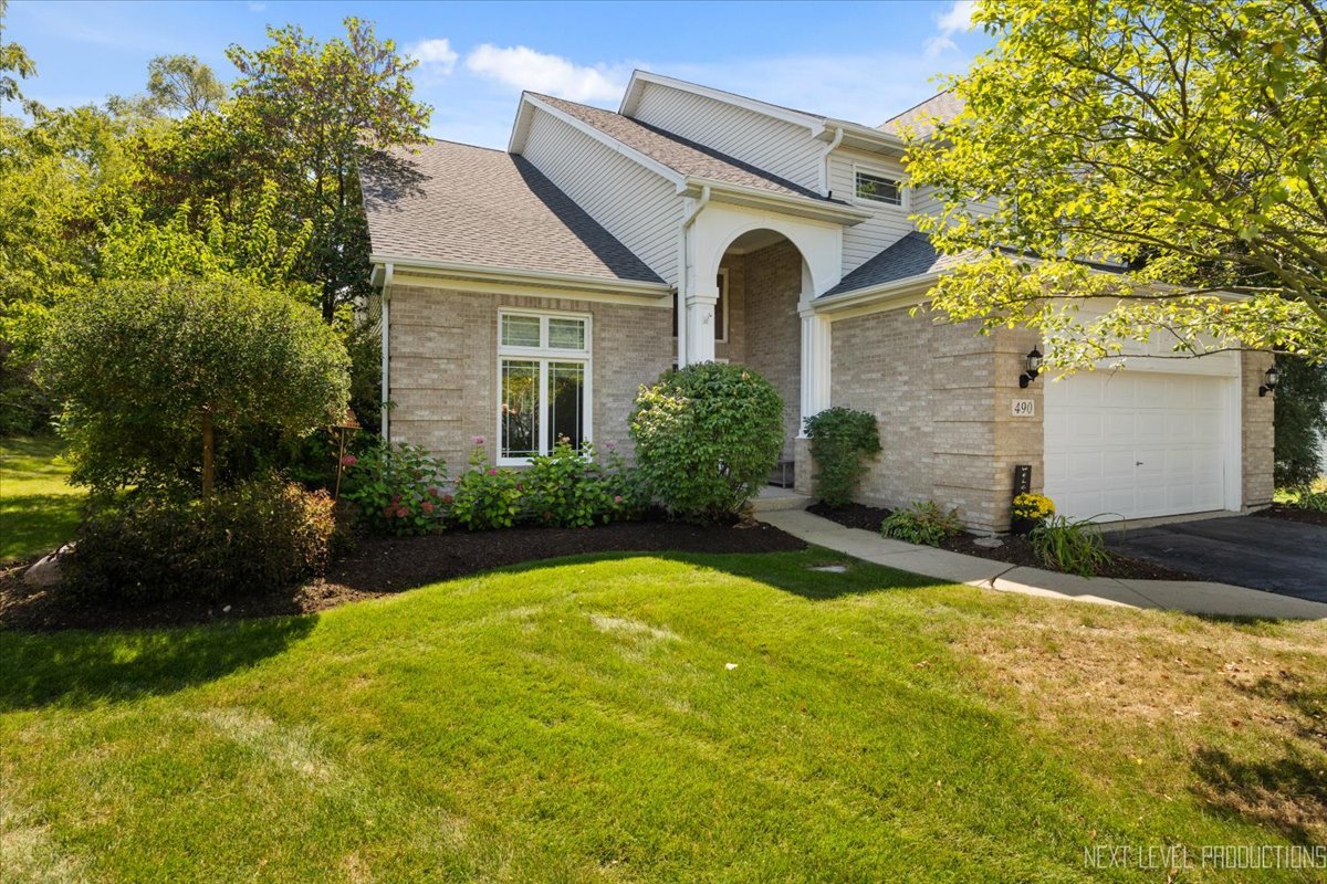 a front view of a house with garden