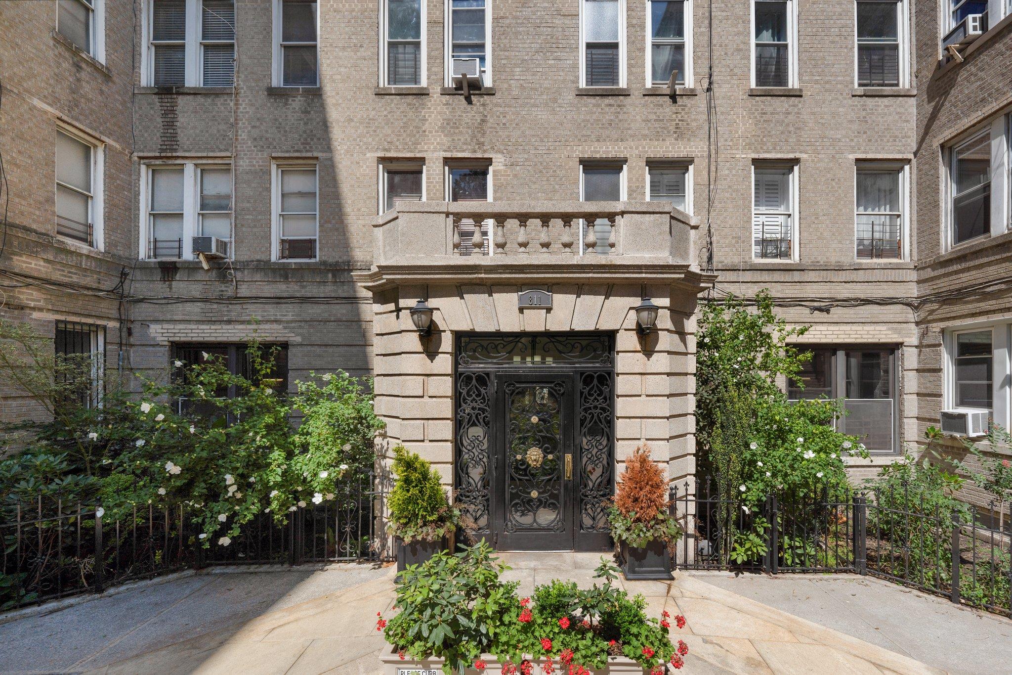 Property entrance featuring cooling unit