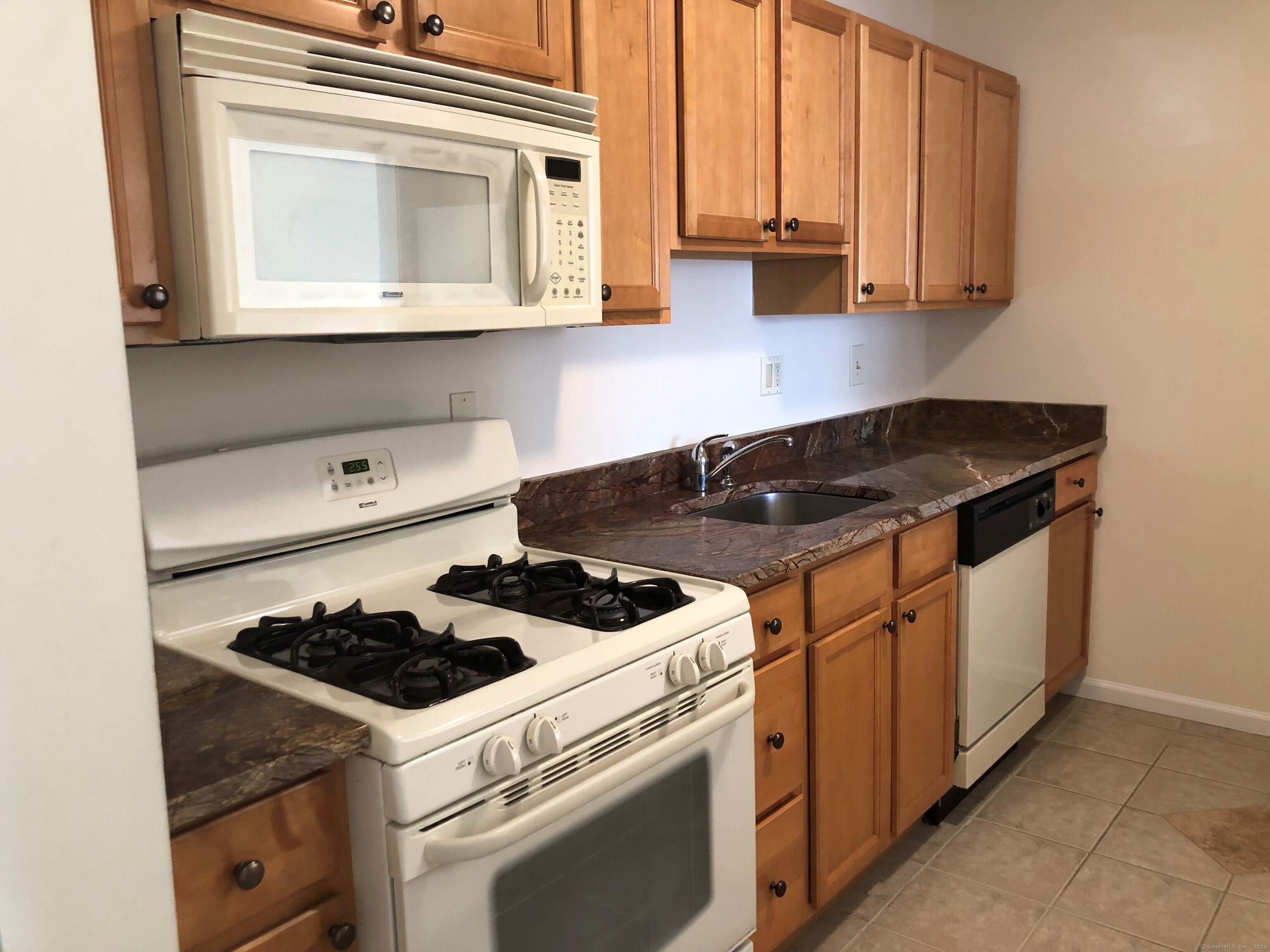 a kitchen with stove and cabinets