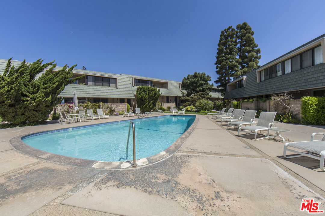 a view of swimming pool with outdoor seating and plants