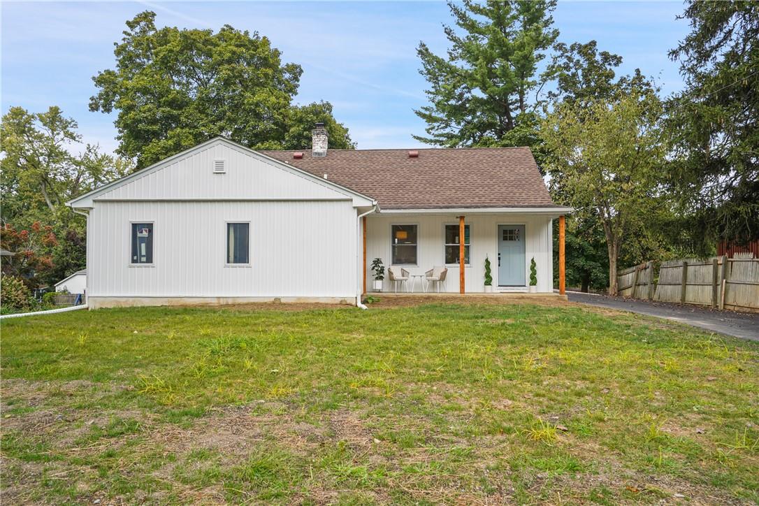 View of front of home with a front yard and a porch