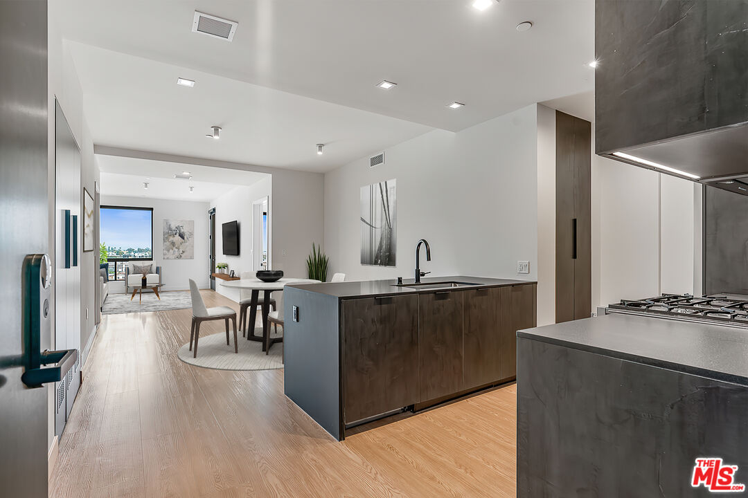 a large kitchen with lots of counter top space and a wooden floor