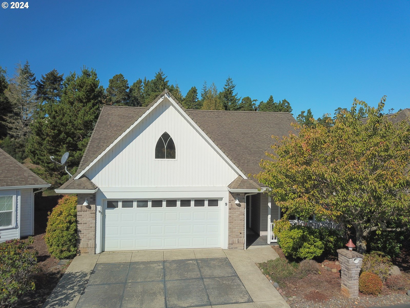 a view of a house with a yard and garage