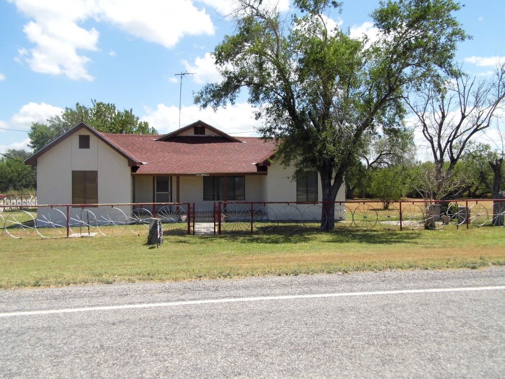 a view of a house with a yard and sitting area