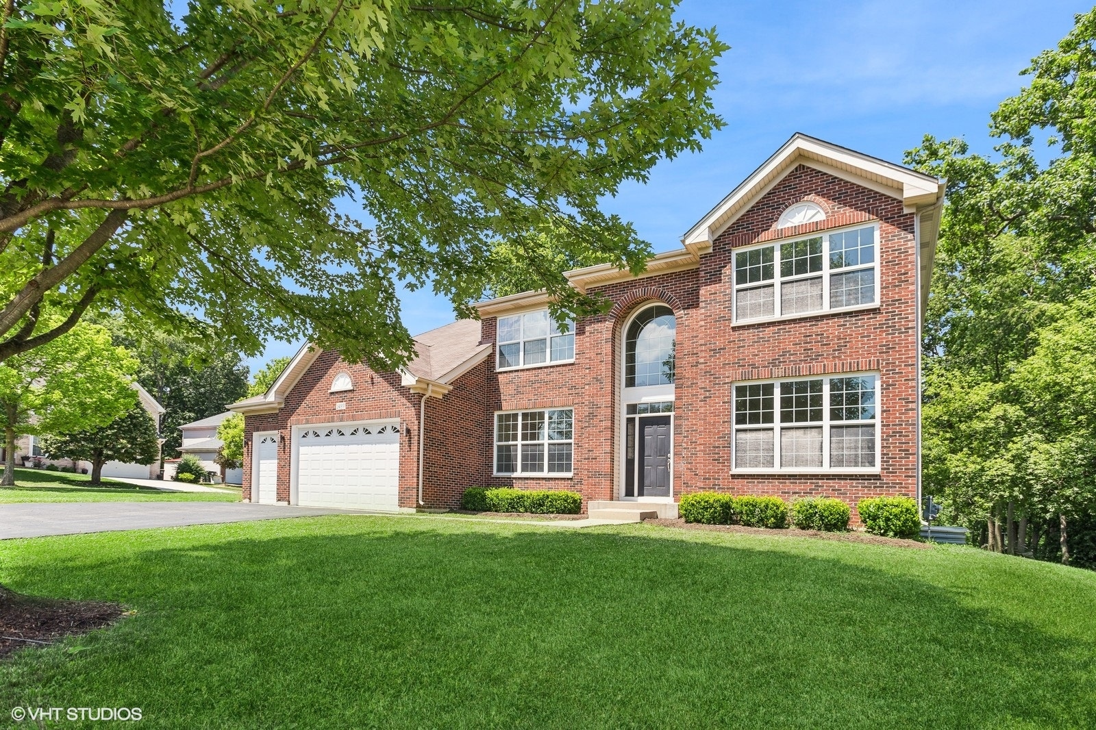 a front view of a house with a yard and garage