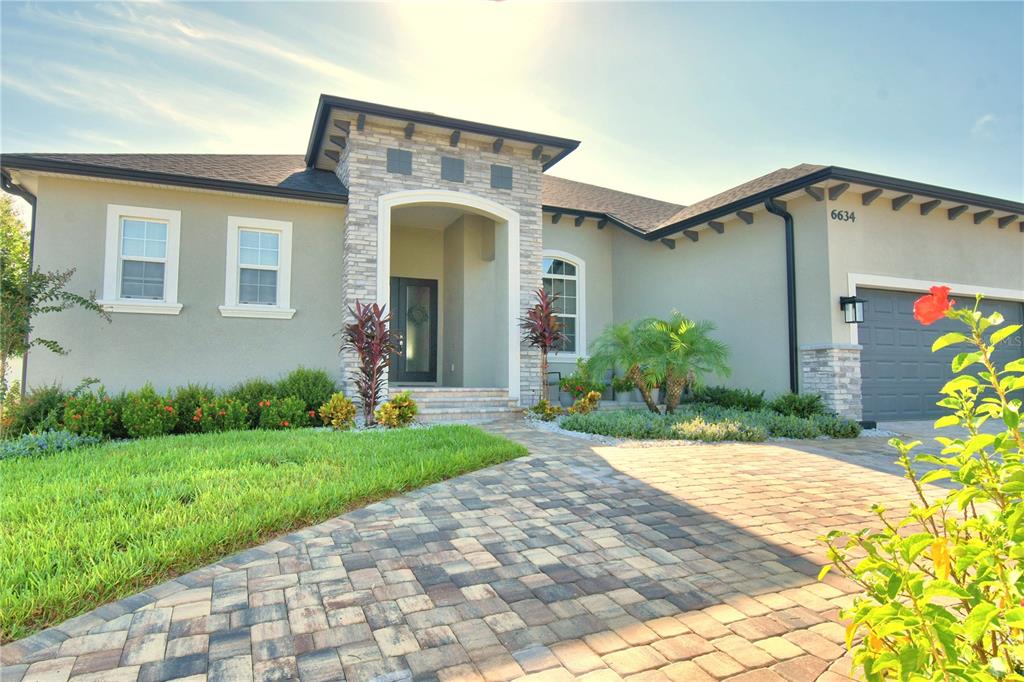 a front view of a house with garden