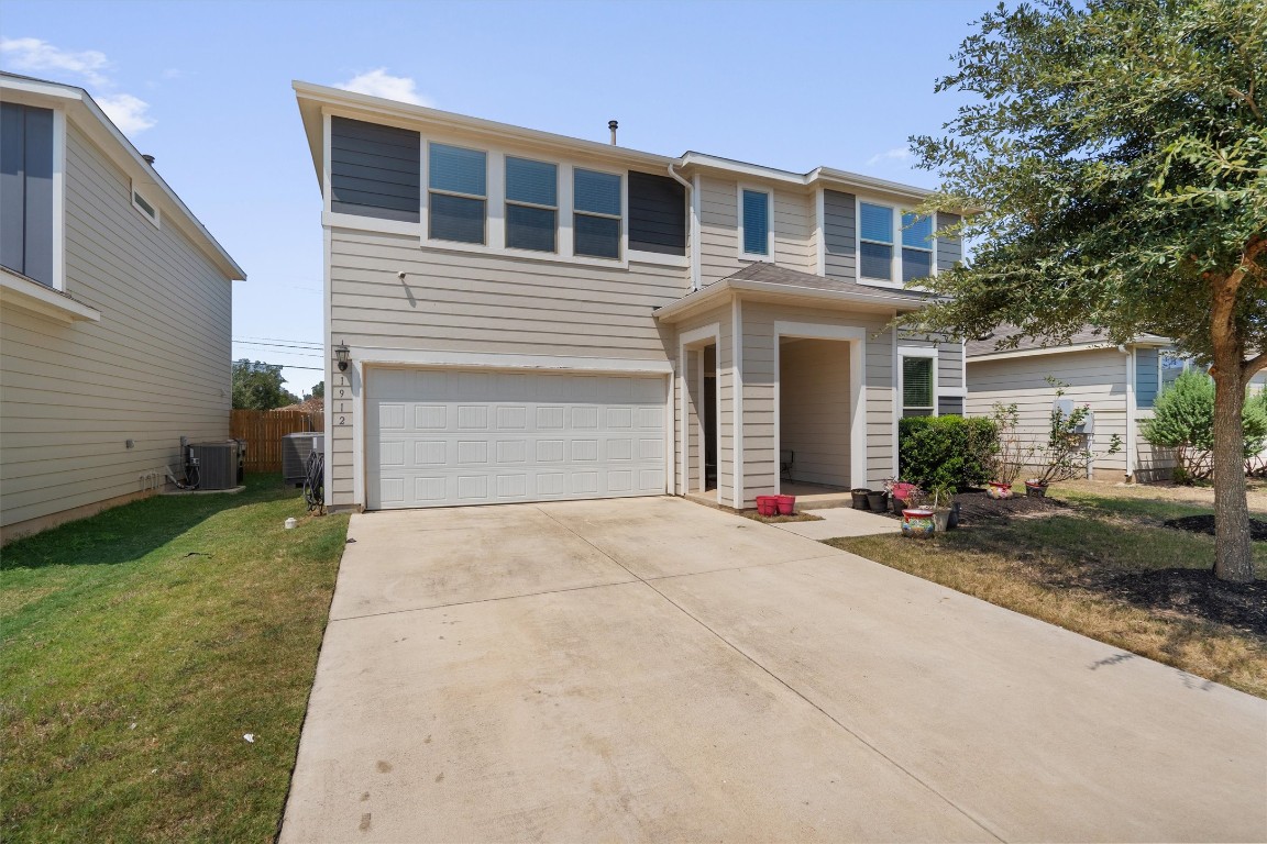 a front view of a house with a yard and garage