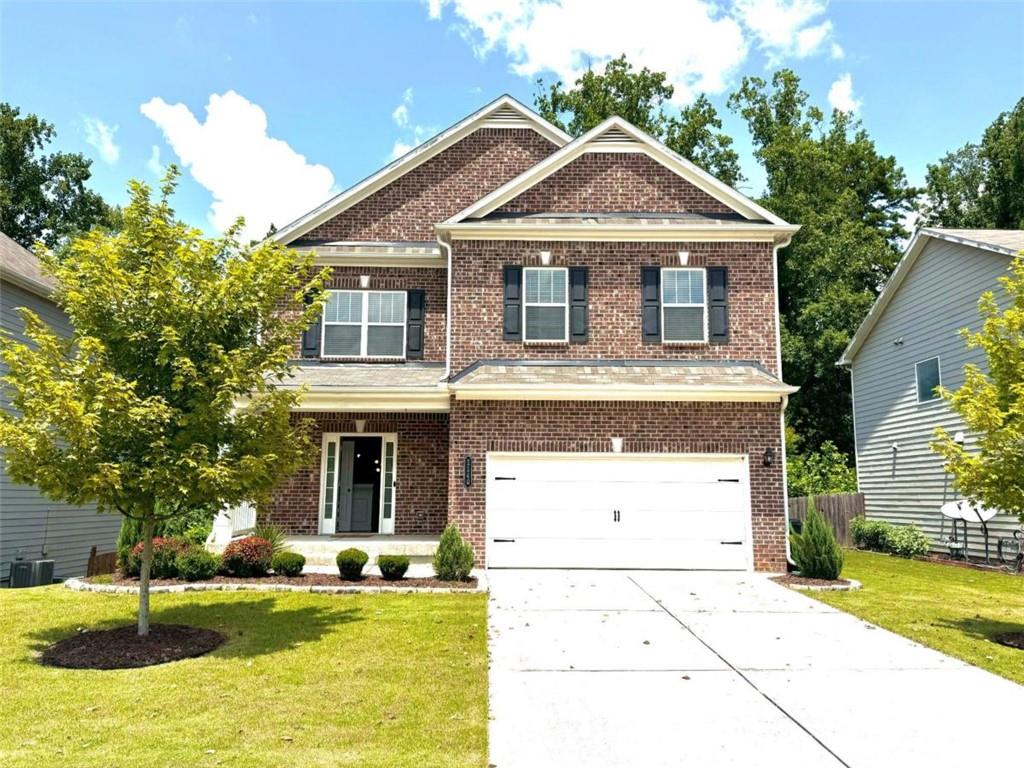 a front view of a house with a yard