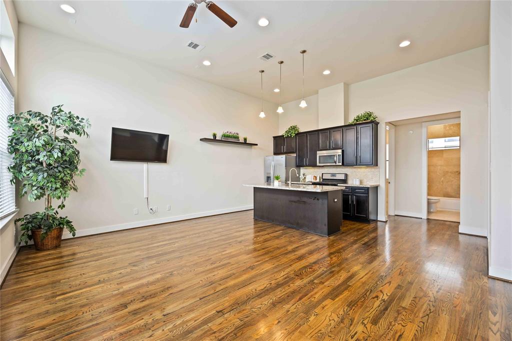 a large kitchen with kitchen island a sink stainless steel appliances and cabinets