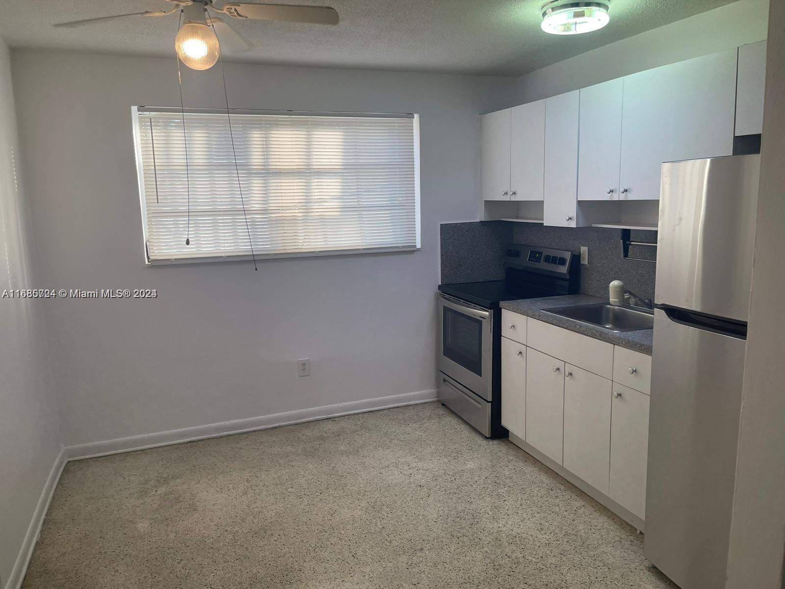 a kitchen with appliances cabinets and a sink