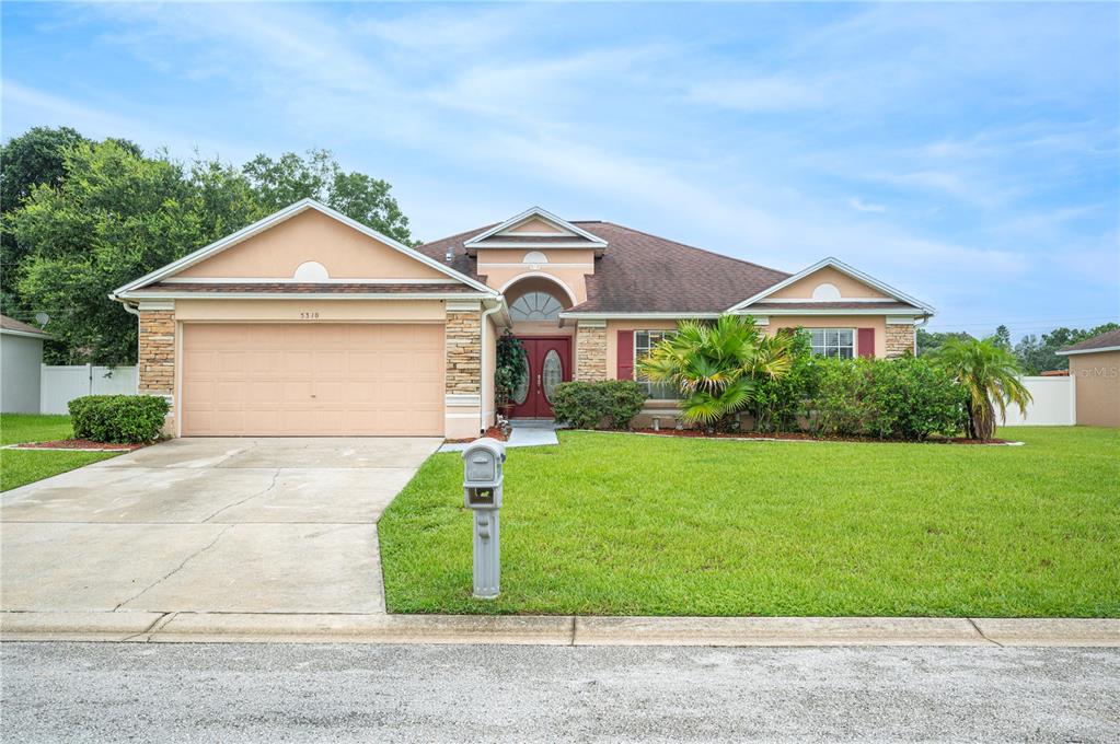 a front view of a house with a yard and garage