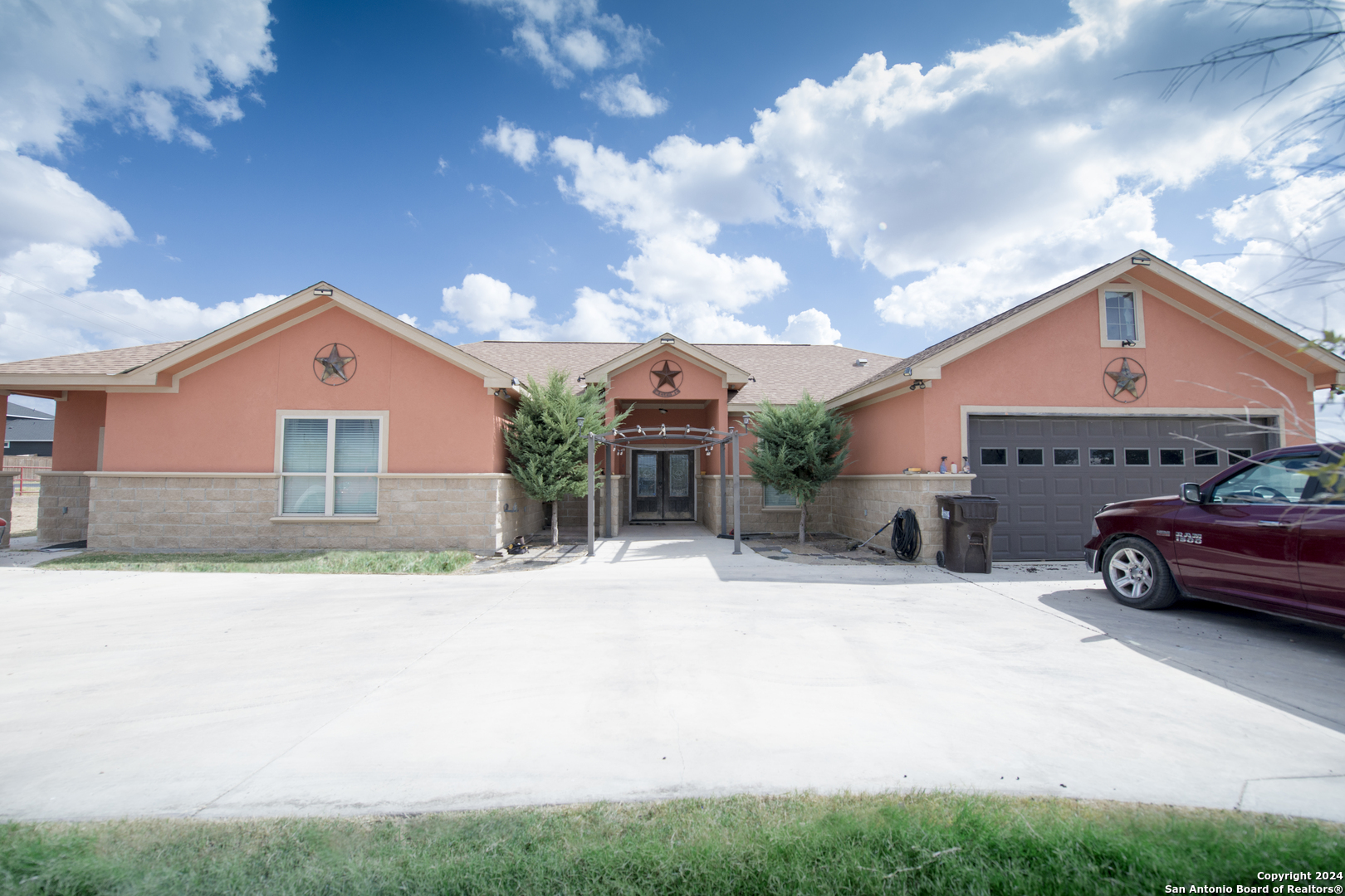 a front view of a house with a yard and garage