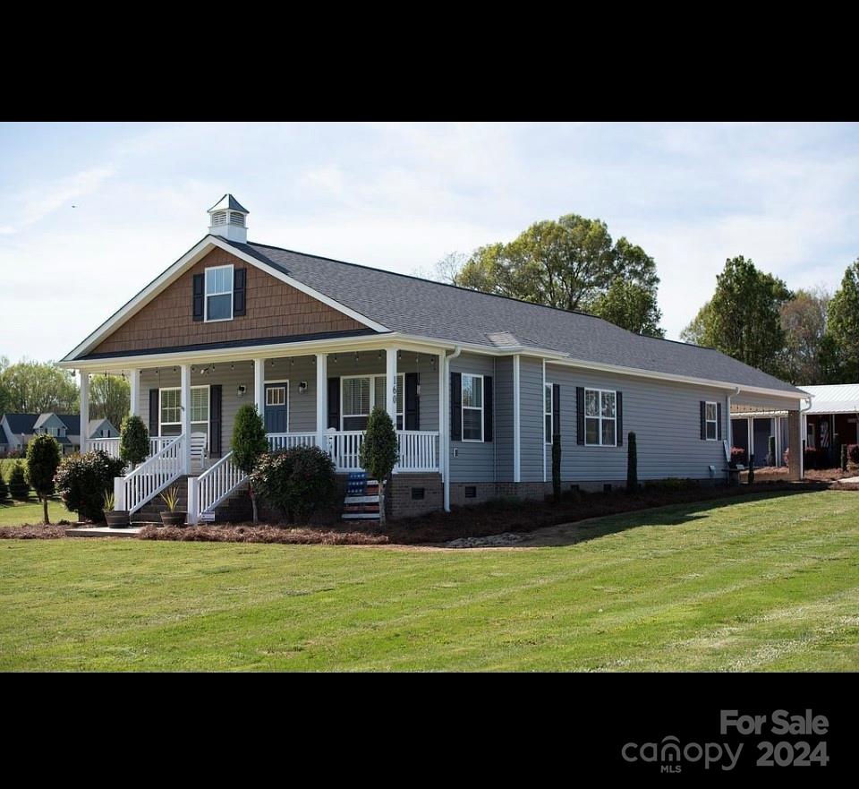 a view of a house with a yard balcony and sitting area