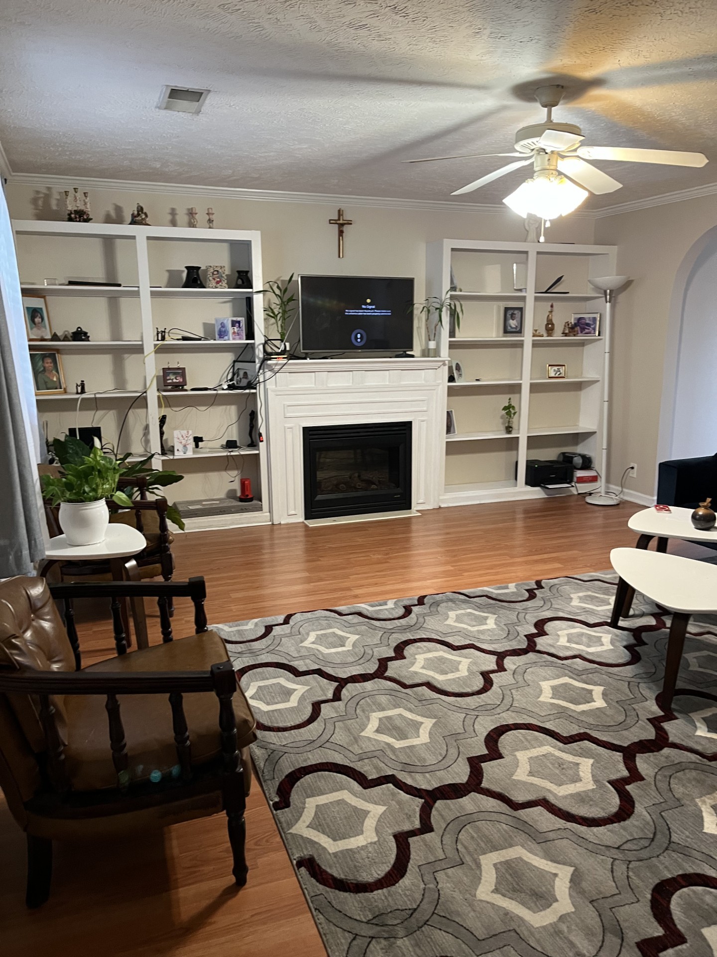 a living room with furniture a fireplace and a flat screen tv