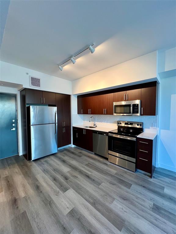 a large kitchen with a stove and a sink