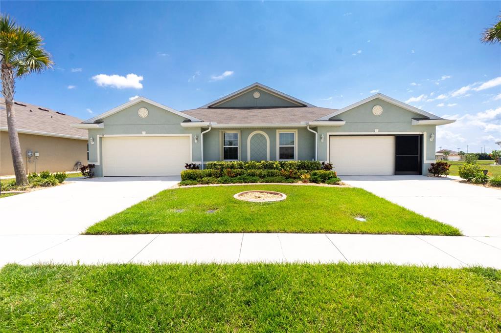 a front view of a house with a yard and garage