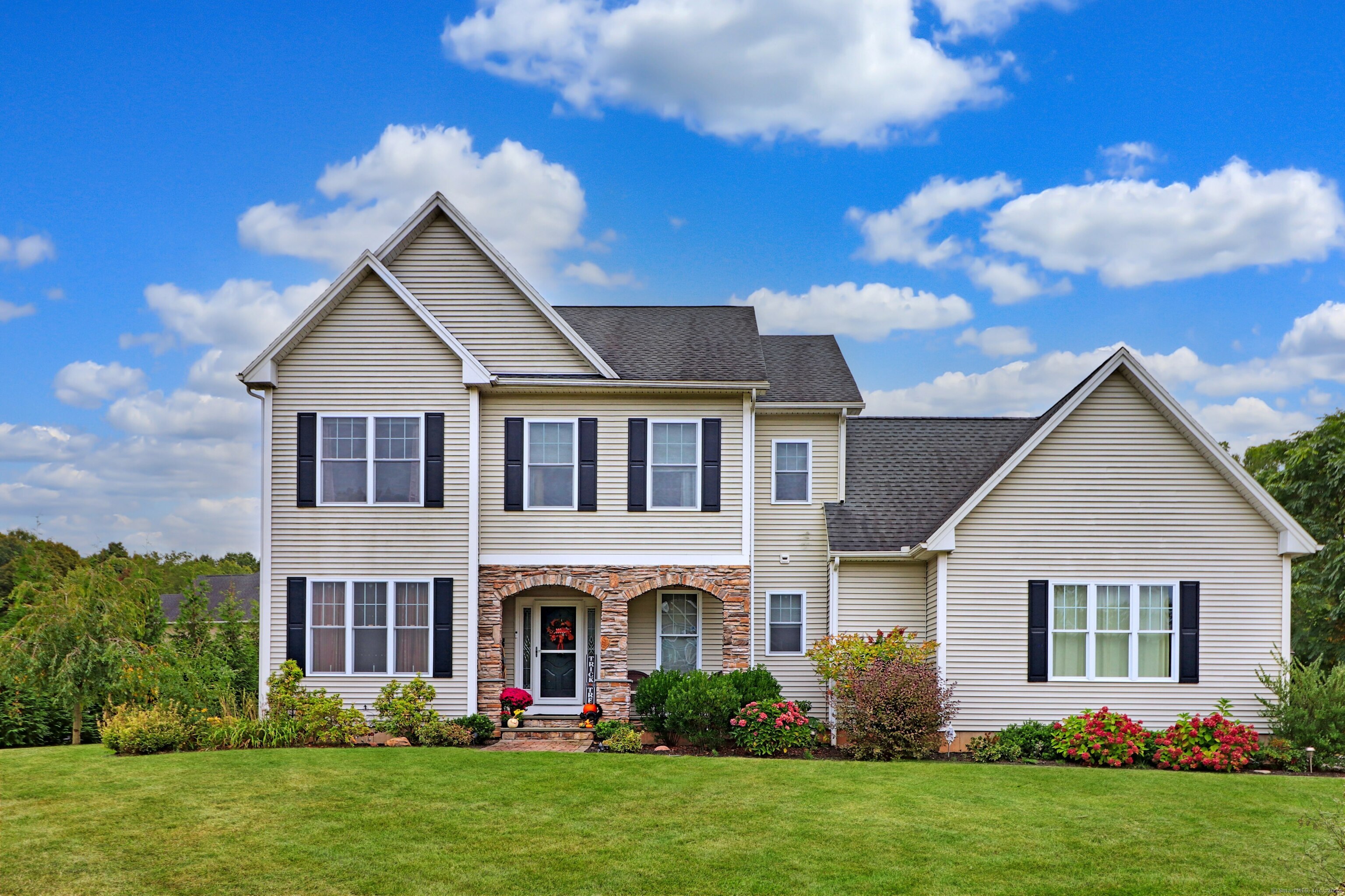 a front view of house with yard and green space