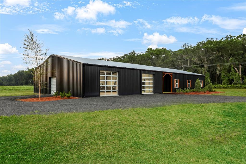 a front view of a house with a garden and trees