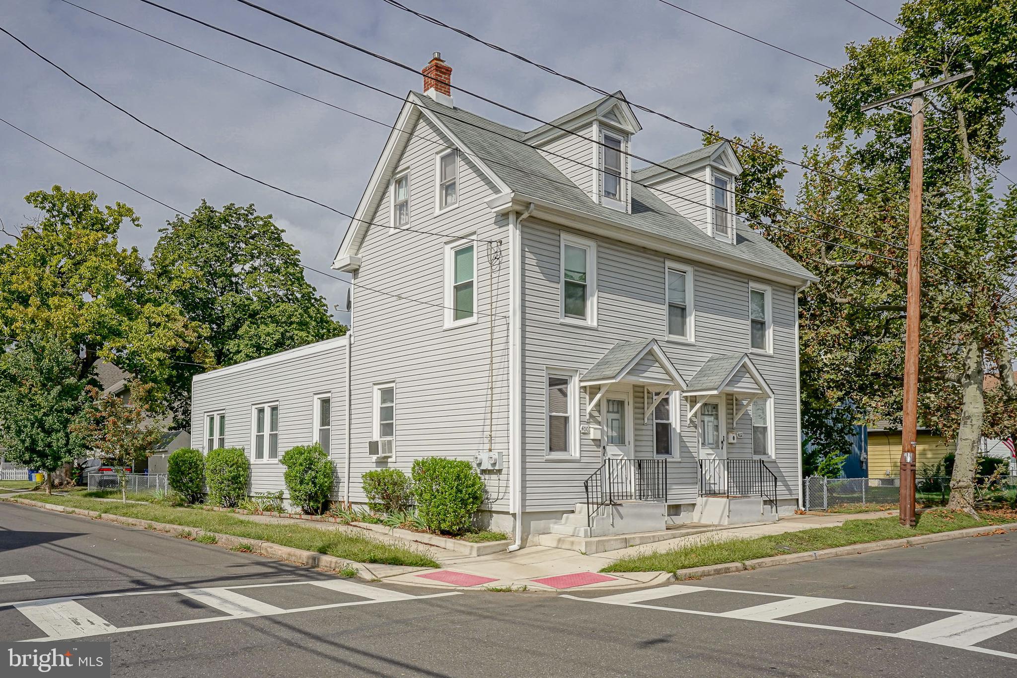 a view of a white house with a street