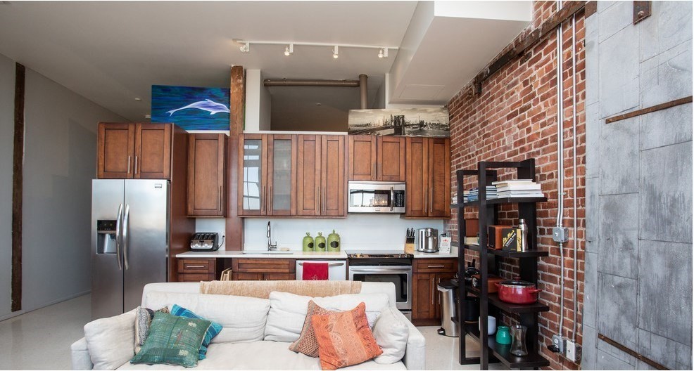 a kitchen view of a kitchen island wooden floor and electronic appliances