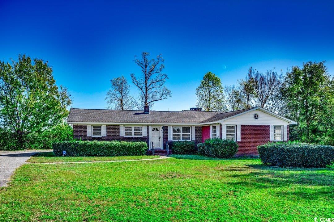 Ranch-style house featuring a front lawn