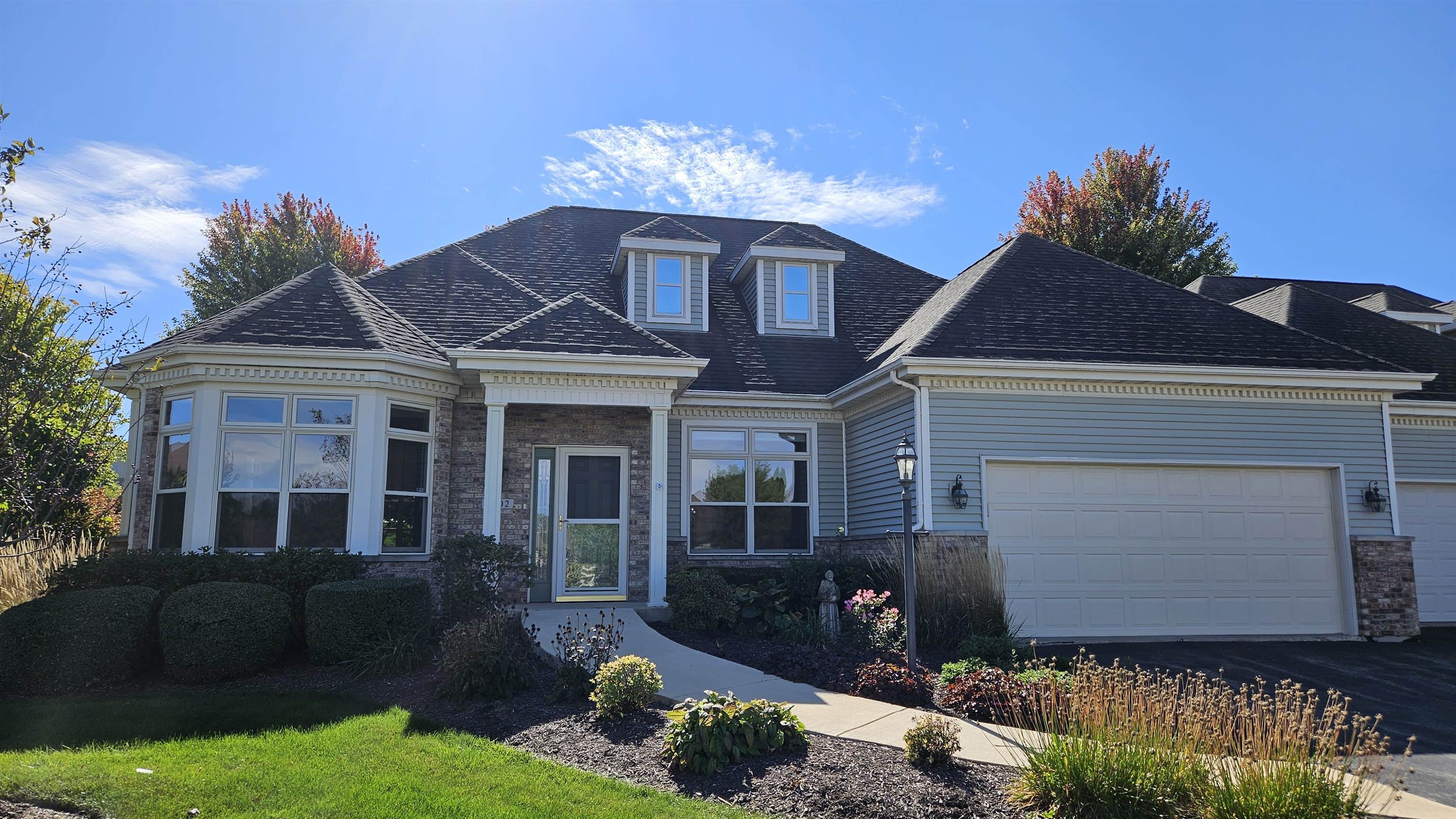 a front view of a house with a yard and garage