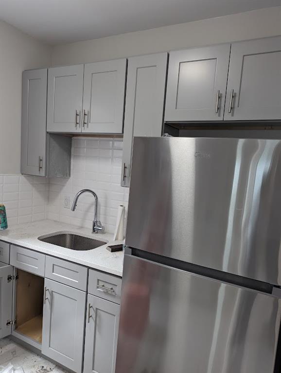 a kitchen with a refrigerator and cabinets