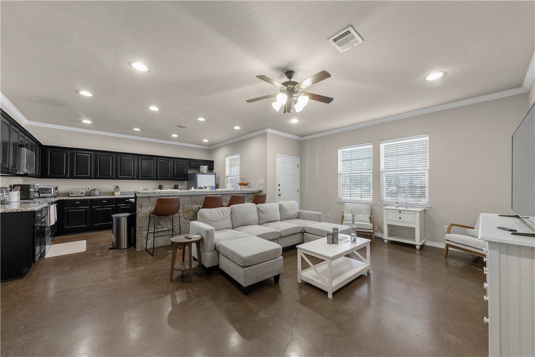 a living room with furniture and kitchen view