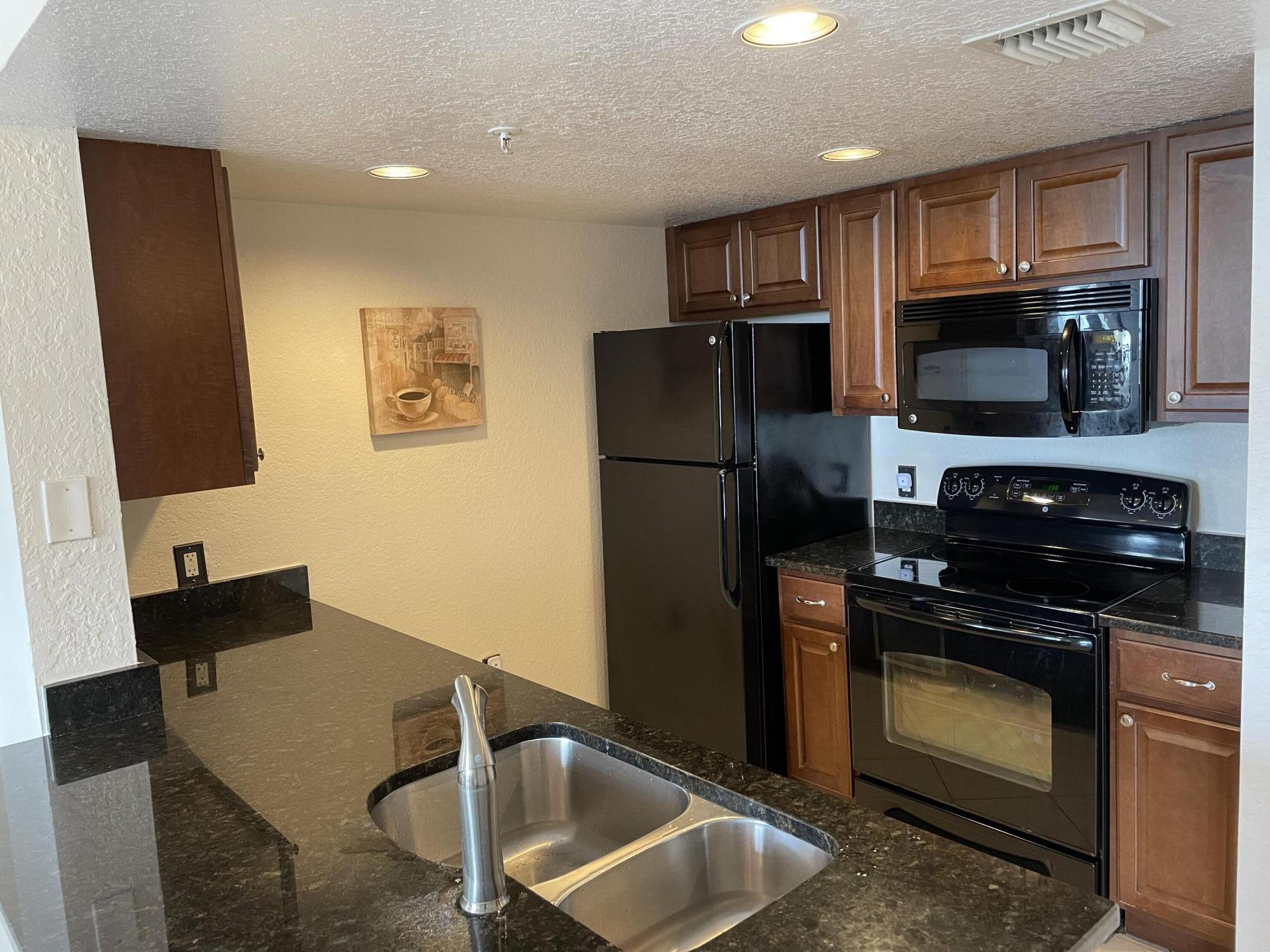 a kitchen with a refrigerator stove and microwave