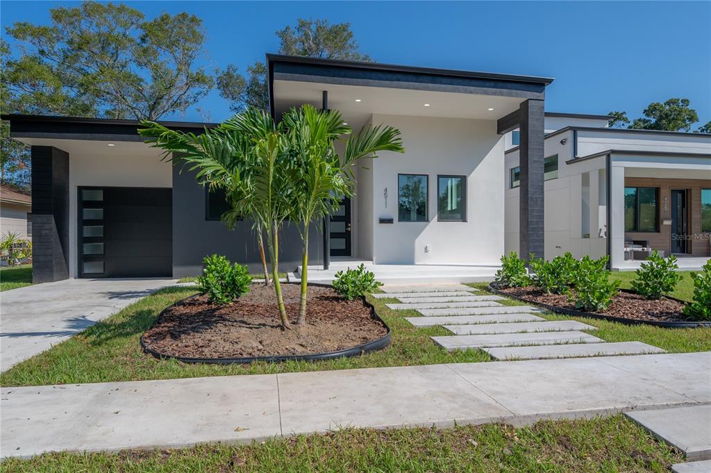 a front view of a house with garden