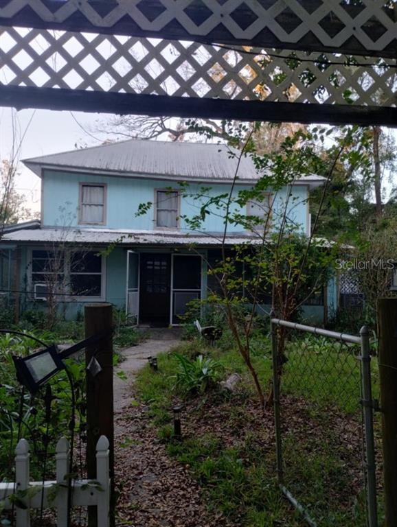 a front view of a house with a yard garage and outdoor seating