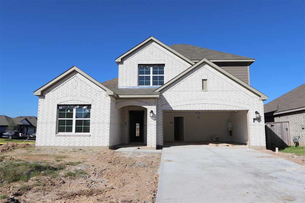 a view of a house with a yard and garage