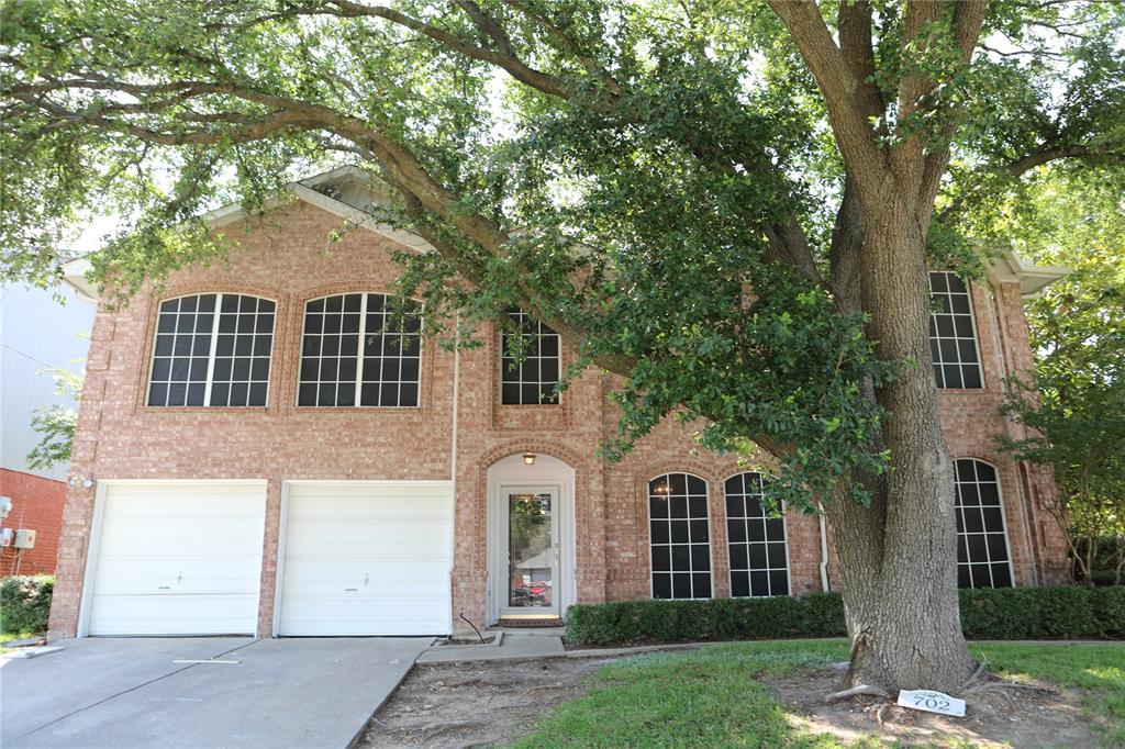 front view of a house with a garden