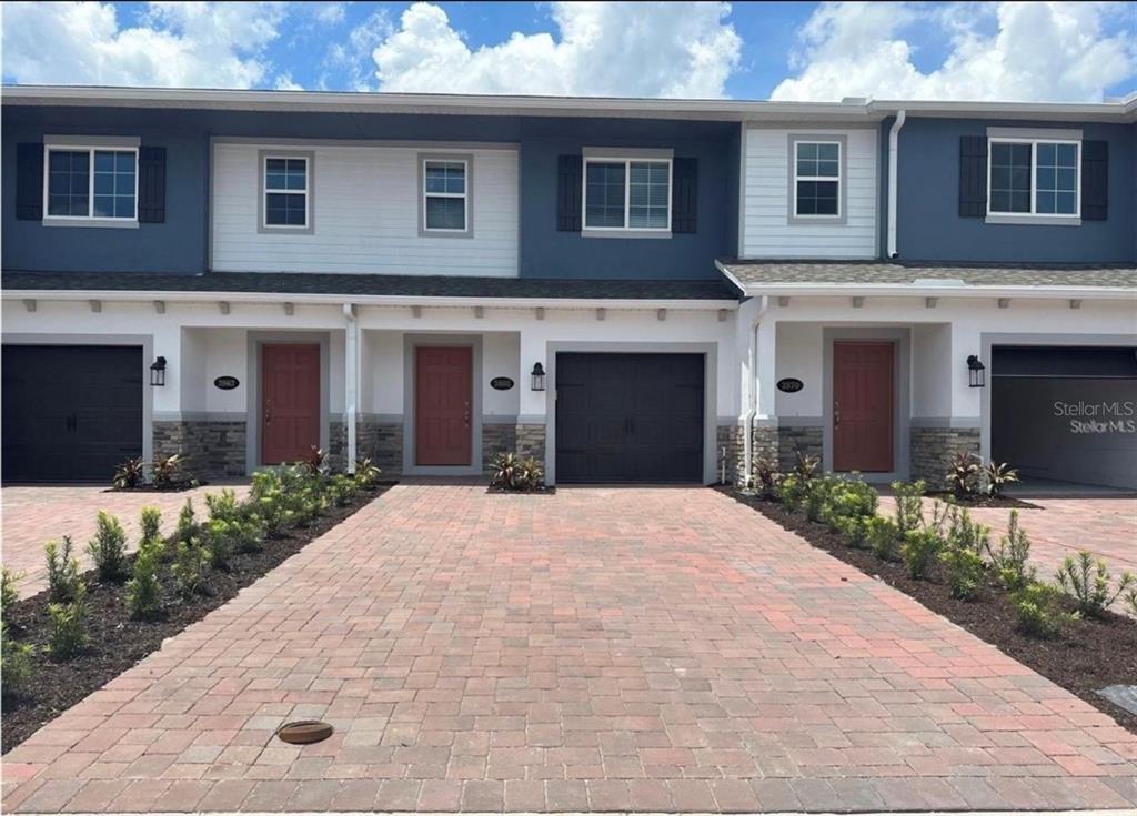 a front view of a house with a yard and garage