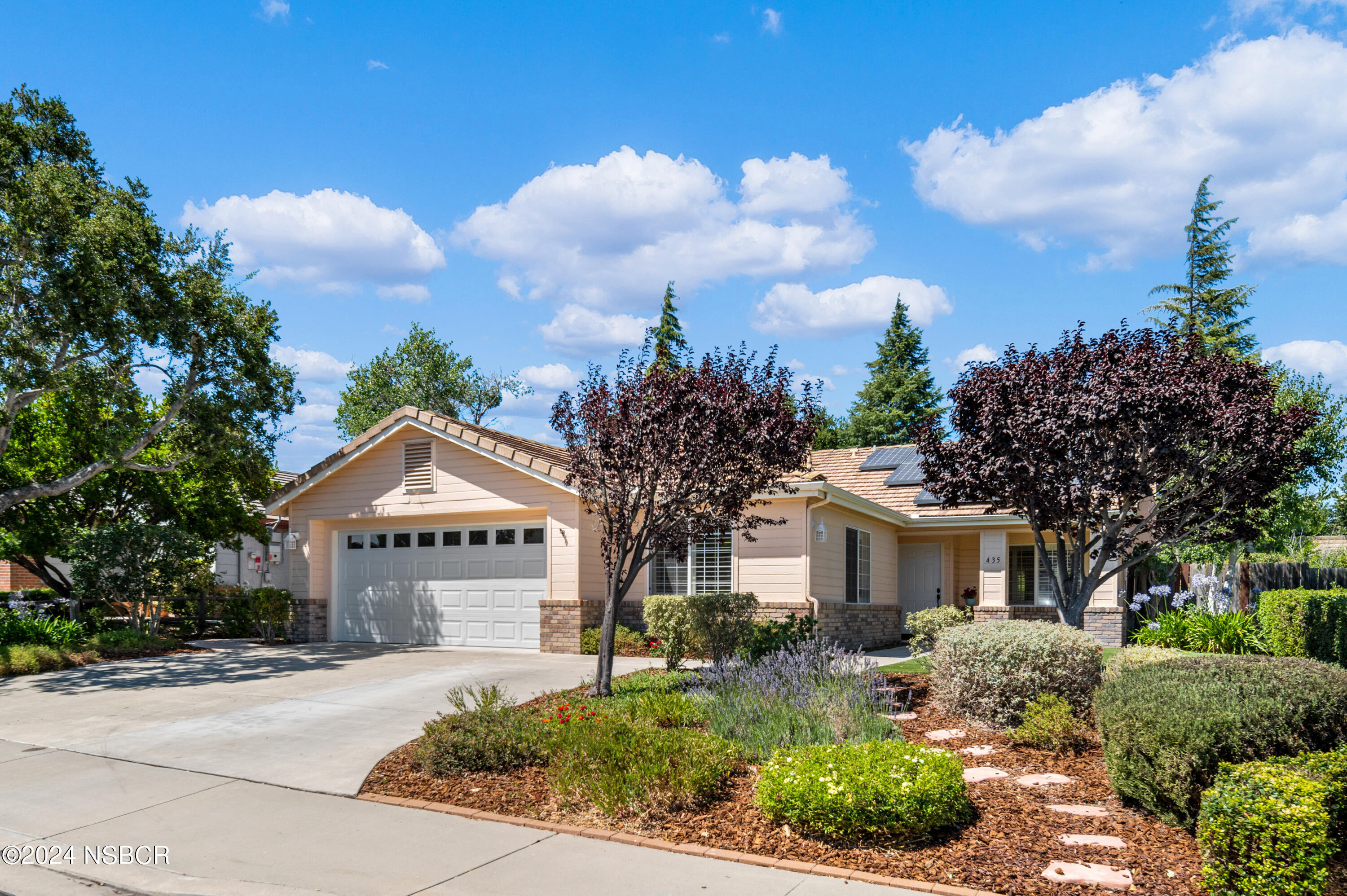 a front view of a house with garden