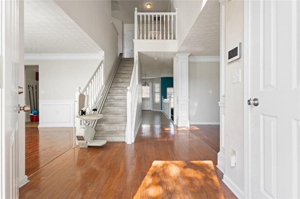 a view of entryway and hall with wooden floor