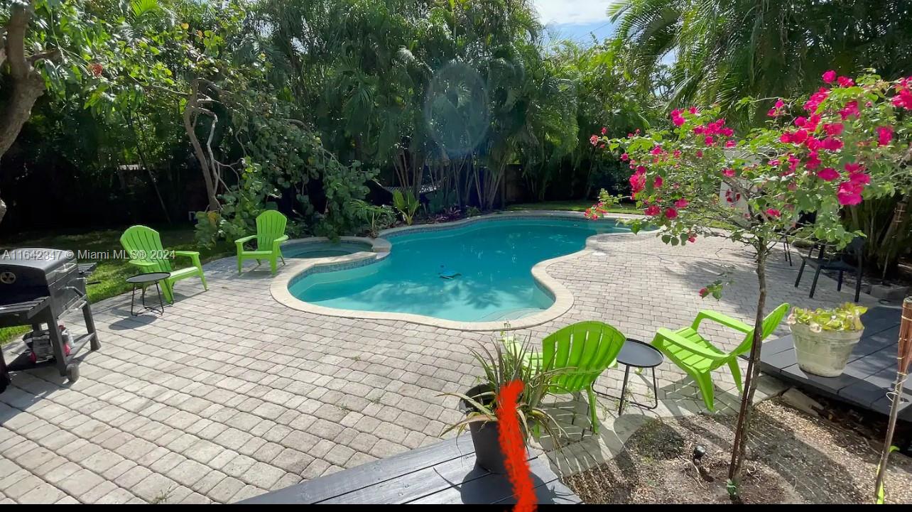 a view of yard with swimming pool and furniture