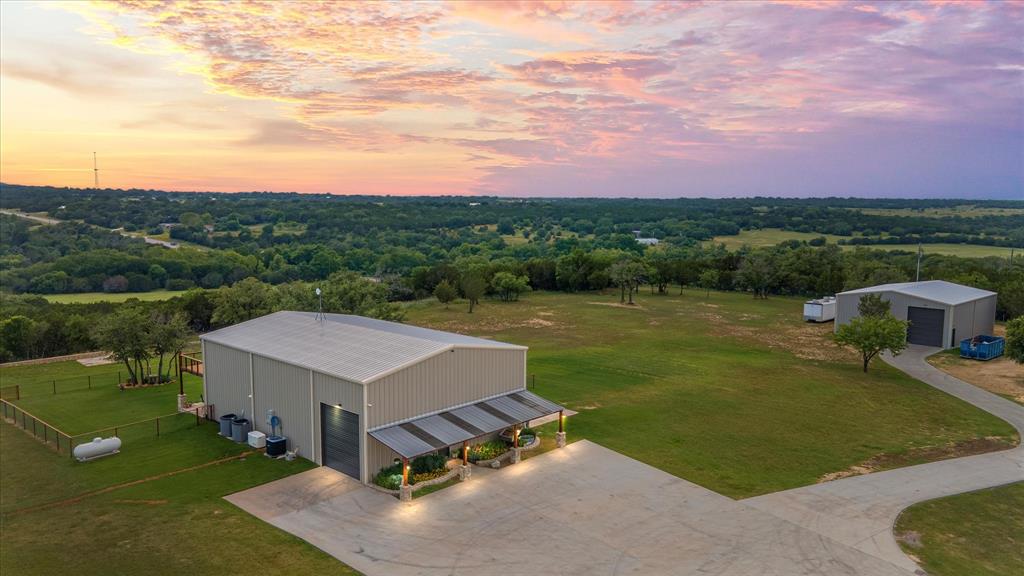 an aerial view of a house having yard table and chairs