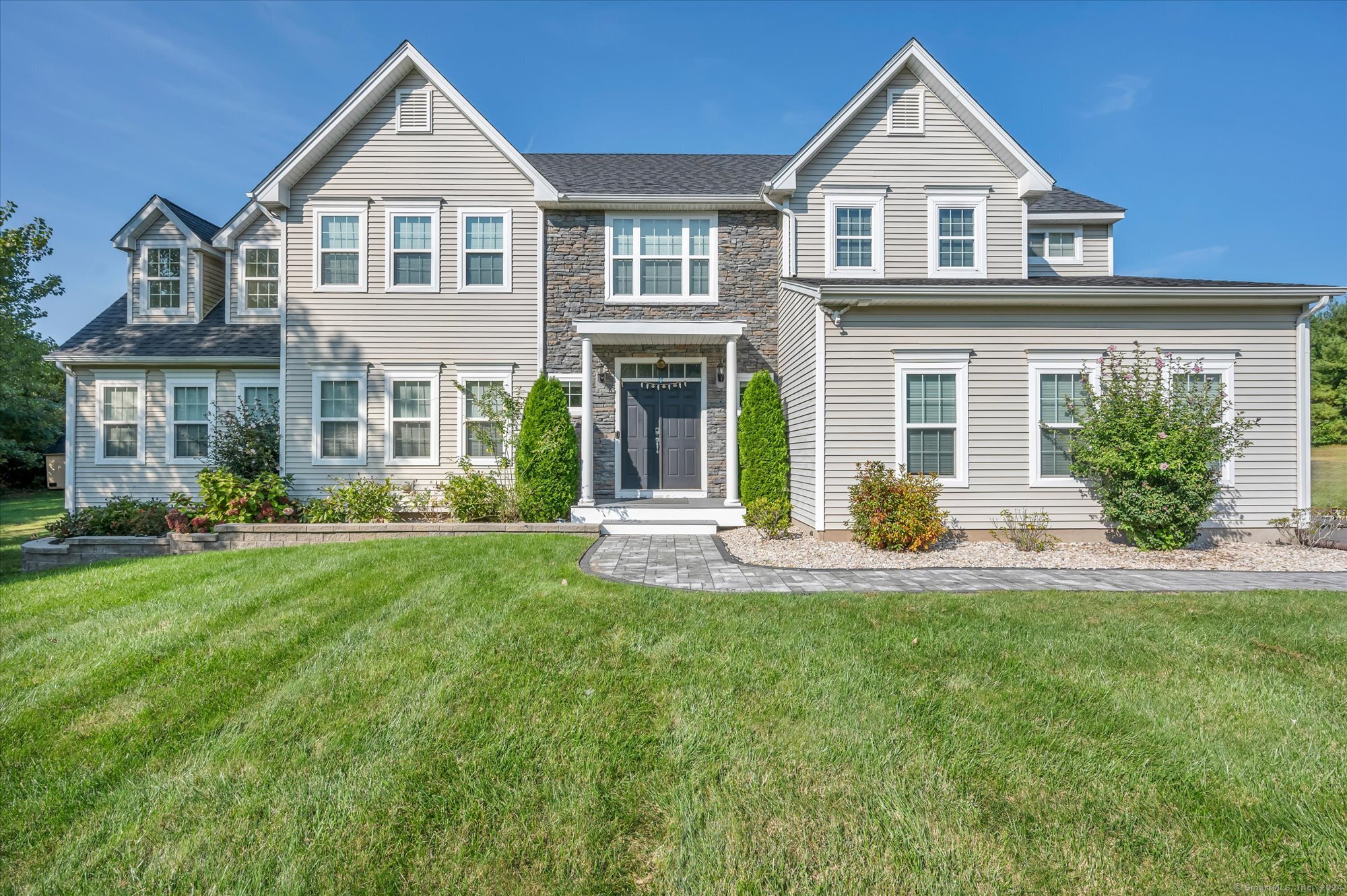 a front view of a house with a yard