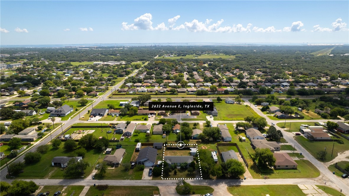 an aerial view of residential houses with yard