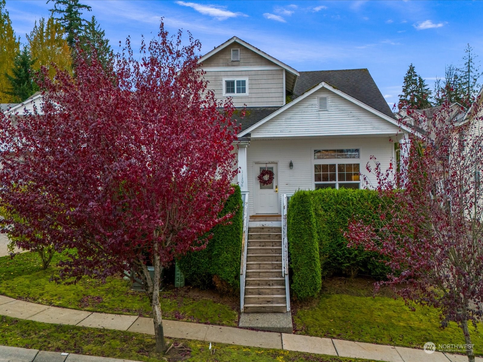 a view of a house with a yard and plants