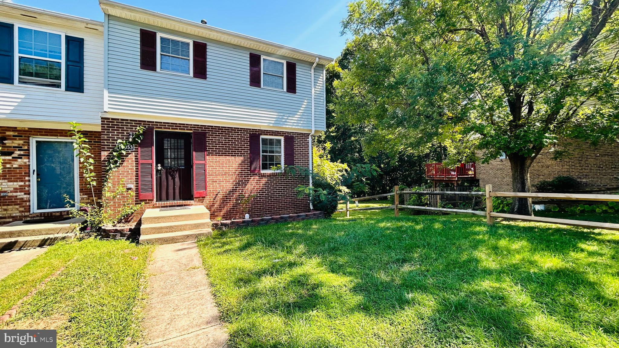 a view of a house with a yard patio and a small yard