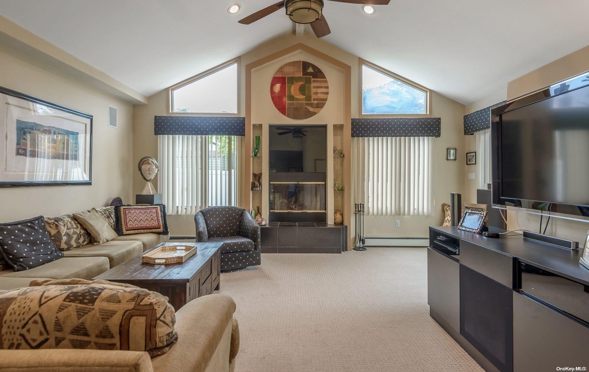 a living room with furniture a window and a flat screen tv